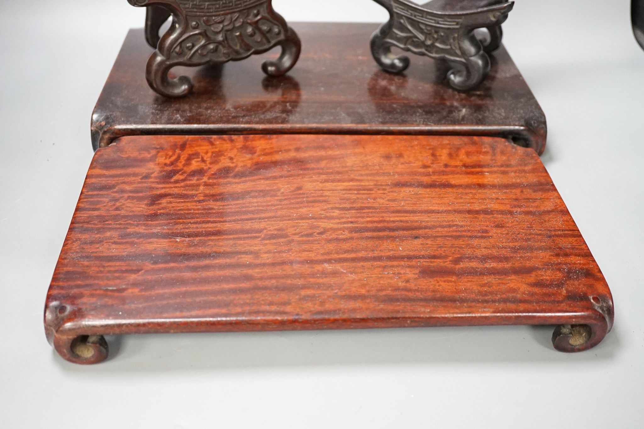 Two Chinese hardwood low stands and two similar plate stands, largest 36cm
